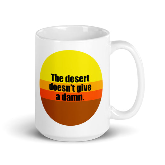 The desert doesn't give a damn. 15 oz coffee mug. front view. overland365.com